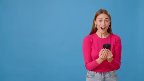 Shocked Female with Phone Saying Wow and Showing Empty Space