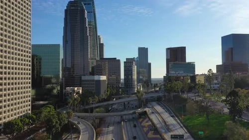 Daytime Traffic On Freeway And Boulevard With View Of High-rise Hotel Buildings In Los Angeles Downt