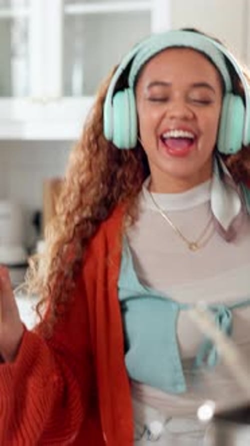Woman Cooking and Dancing with Headphones in Kitchen