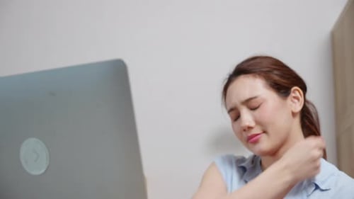 Young caucasian business woman working on laptop computer in office while pain muscle neck.
