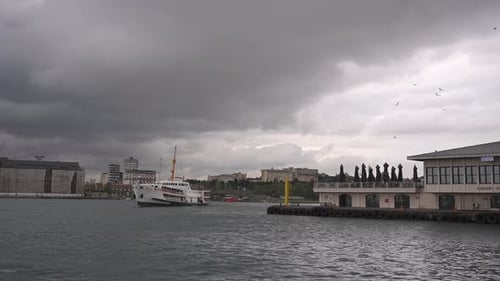 At the Kadıköy pier, in cloudy weather, ships are sailing, birds are flying, on the Bosphorus.