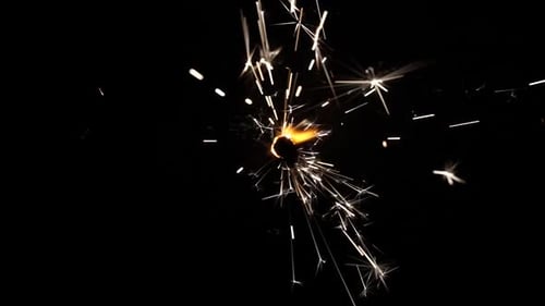 Sparkler Burning with Bright Sparks in the Darkness