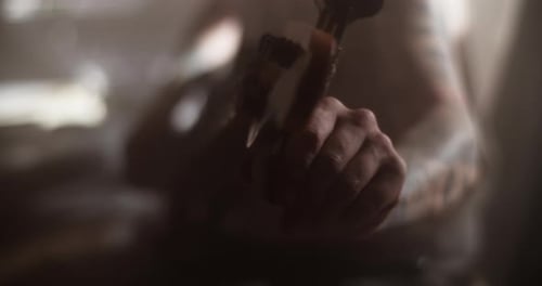 Guitarist Tuning Bass Guitar in Recording Studio