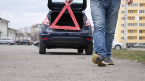 K60. Emergency stop sign on the background of the car with the alarm system on.