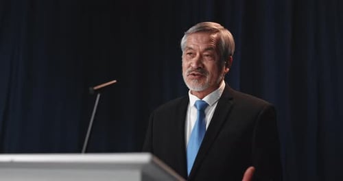 Professional Man Giving a Speech at Podium