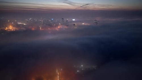 Fog Shrouded Cityscape at Dusk Aerial