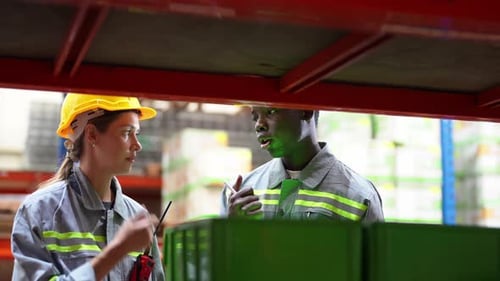 Warehouse Industrial and Logistics Companies. Dispatcher in uniform making inventory in storehouse.