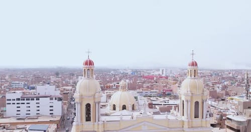 Amazing general drone shot of the dome of the cathedral of the city of Chiclayo with houses and buil