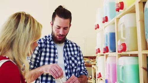Friendly shop assistant serving a woman in a zero waste organic store