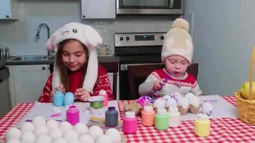 Two Joyful Children Decorate Easter Eggs for the Easter Holiday