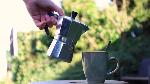 Coffee being poured from stovetop espresso maker