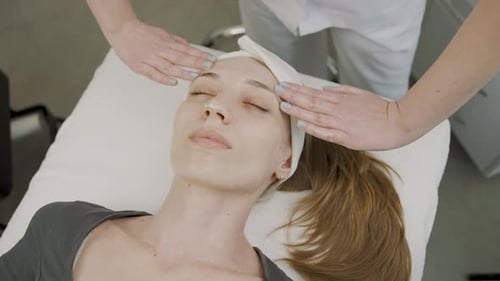 Woman Receiving Relaxing Facial Massage at Spa