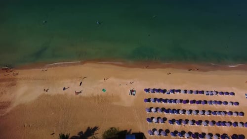 Paradise Sand Beach with Sunshades and Relaxing Tourists Enjoying Seascape Filmed By Drone