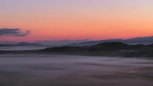 Golden Hour Aerial Flyover of Foggy Fields at Sunrise in Serene Light