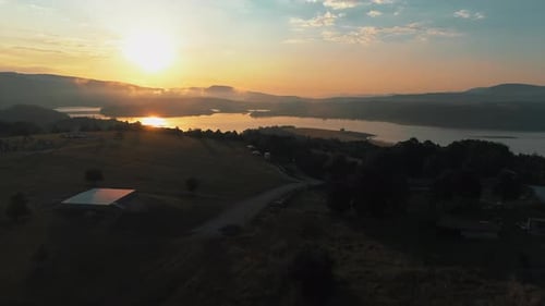 a beautiful sunrise behind the mountains and a lake that reflects the sunrise