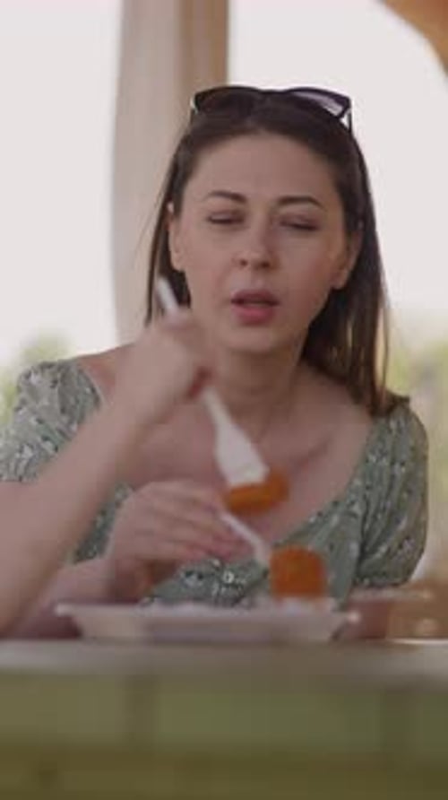 Mother and Little Girl Eat Cottage Cheese Pancakes in Cafe