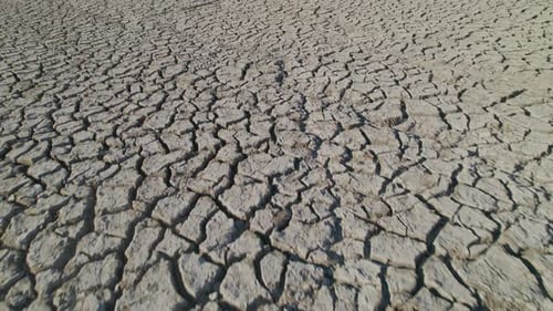 Dry soil with cracks through the mud in the desert during drought