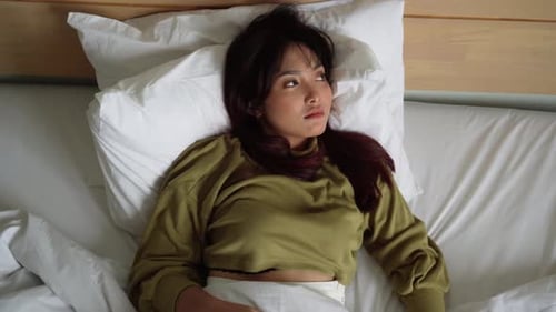 Woman Sleeping and Stretching in Bed