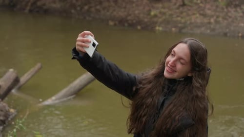 Woman Selfies Tranquil Nature Woman By River Captures Serene Moment Caucasian Lady Takes Peaceful