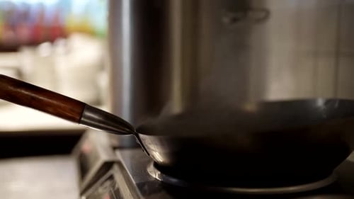 Cooking Wok in Small Chinese Restaurant Closeup of Cook Hand and Pan on Stove Traditional Cuisine
