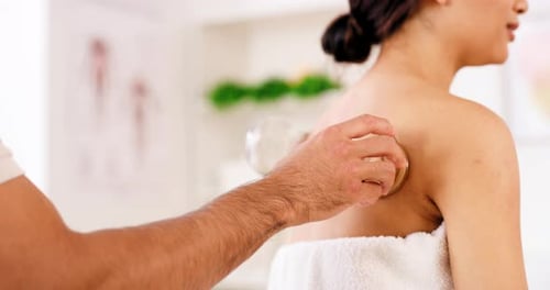 Hand, physiotherapy and woman in cupping therapy at a spa for blood circulation