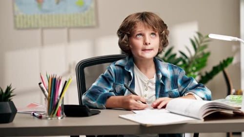 Young Boy Doing Homework at Desk