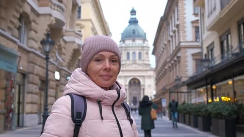 Woman Against Facade of Gothic Place