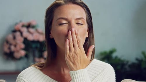 Woman Blowing Kiss With Gentle Smile