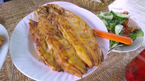 Delicious grilled whitefish or sea bream with lemon slices,