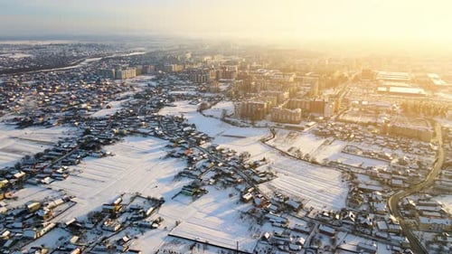 Aerial View of Private Homes with Snow Covered Roofs in Rural Suburbs Town Area in Cold Winter