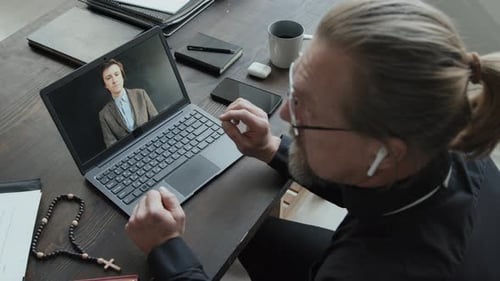 Minister Having Online Video Call Reading Prayer Book
