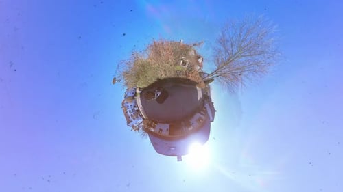 Little Tiny Planet 360 Small World View Of A Man Walking Near Street with Music Video Burn Effect in