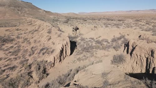 Flying over dry desert river bed wash in Utah