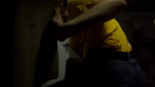 Following Back Shot of Female Plumber in Dark Basement Heading to Boiler Room Woman Engineer Walks