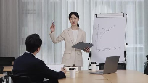 Business Presentation in Conference Room with Charts and Laptop