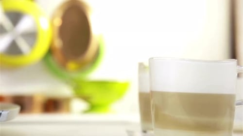 Close Up of Two Layered Latte Macchiatos in Glass Mugs