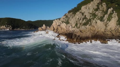 Raging Sea in the Morning at Dawn Waves Roll on the Rocky Shore Spray Soars Into the Sky