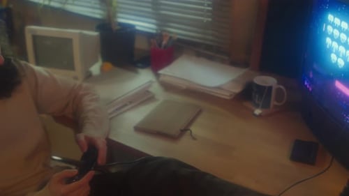 Young Adult Playing Retro Game at Home