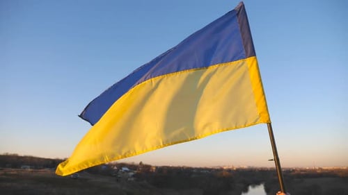 Ukrainian Flag Waving in the Breeze at Sunset