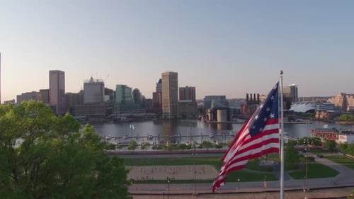 American Flag Waving Over Baltimore Inner Harbor Skyline