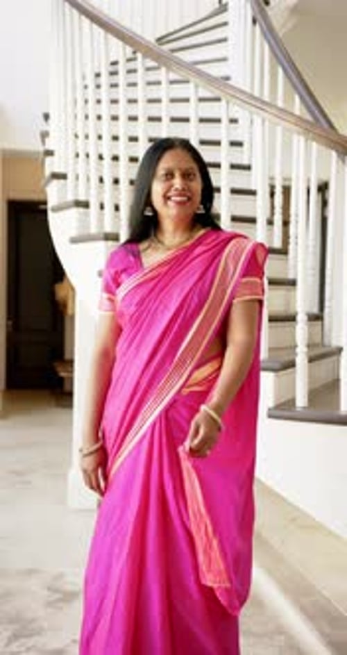 Woman in Pink Sari Poses by Staircase