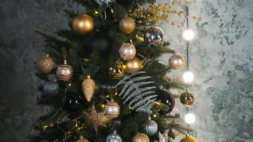 Close Up of Christmas Tree Decorated with Gold Shiny Balls Garland Light