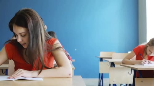 Education, People and Learning Concept - Group of Students with Notebooks Writing