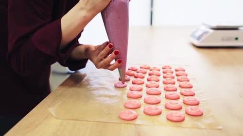 Cooking, Confectionery People Concept - Chef With Confectionery Bag Squeezing Macaron Batter Or M...