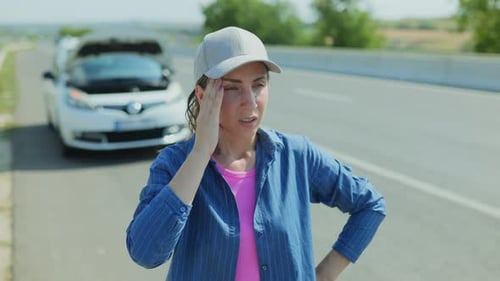 Brunette Female Driver Stranded By Car Breakdown on Freeway