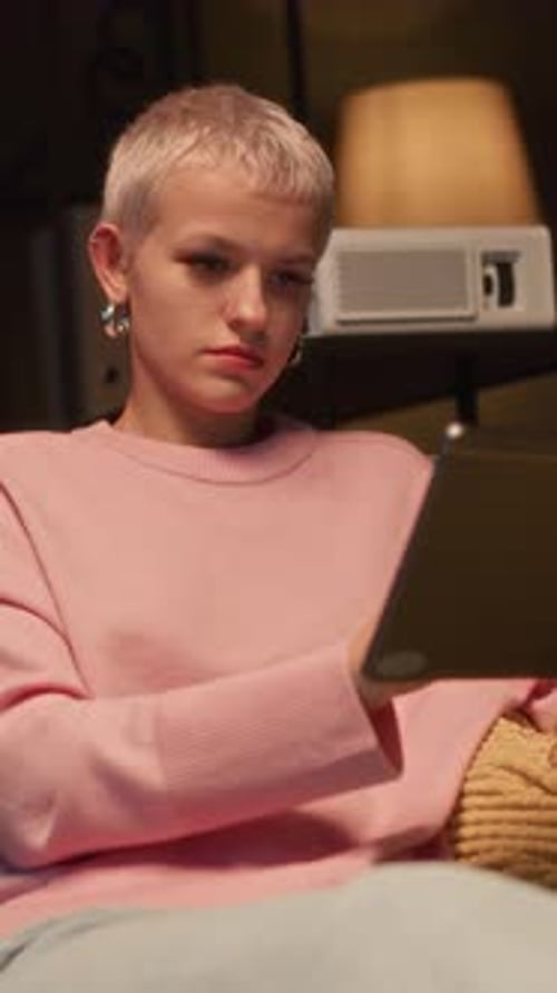 Young Adult Using Tablet Device Indoors