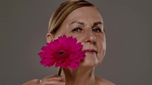 Close Up of Mature Womans Face with Flower Detail