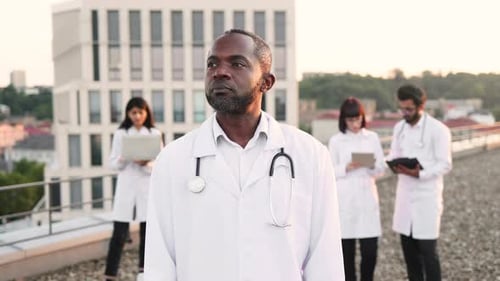 Confident Doctor with Medical Team on Rooftop