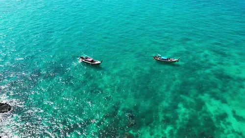 Drone Shot of a Thai Island Shoreline with Sailboats in the Harbor