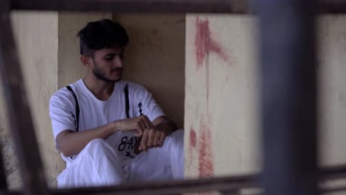 prisoner seating in corner sad-looking guilt India